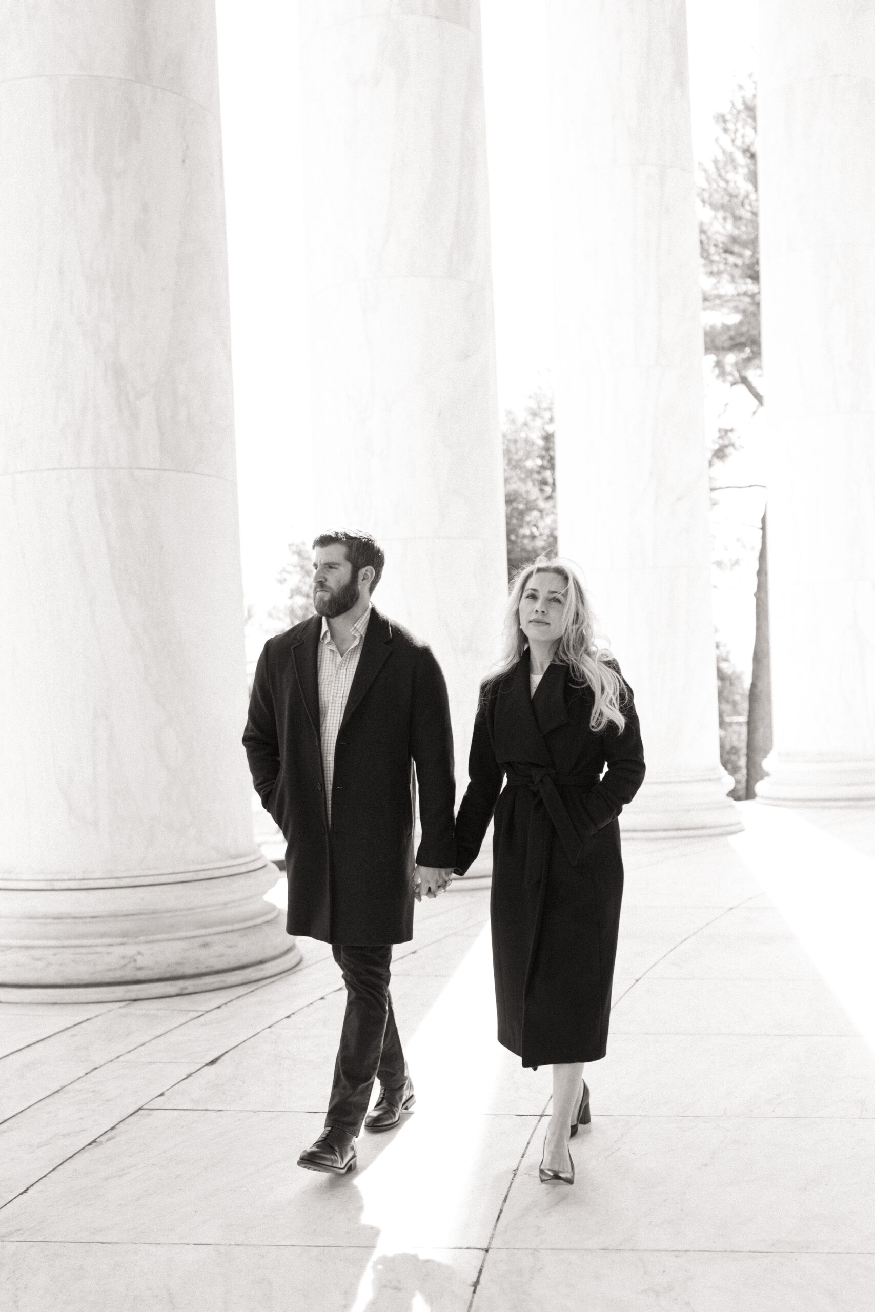 Couple walking hand-in-hand around the Thomas Jefferson Memorial in Washington, D.C.